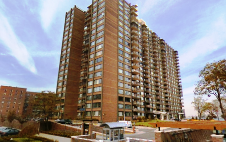 Tall apartment building under blue sky