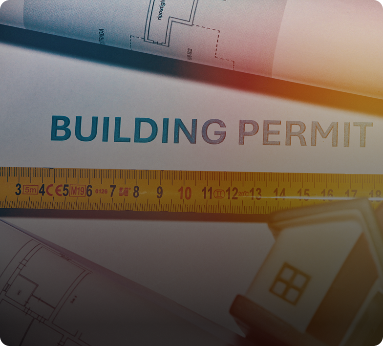 Building permit with architectural plans and ruler.